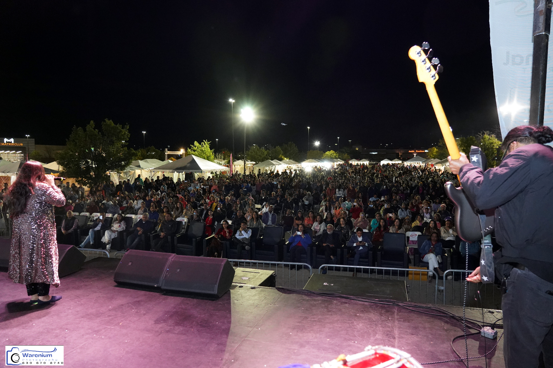 On-stage view of the band performing to a packed audience