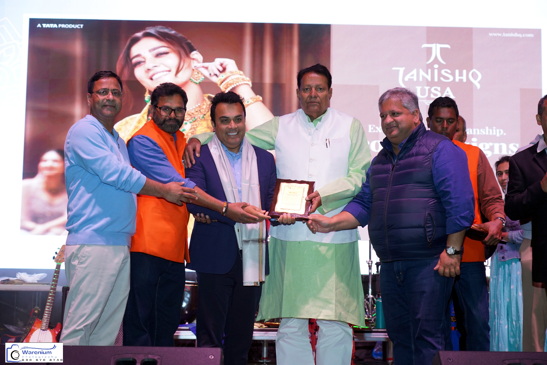 Honored guest receiving an award plaque on stage