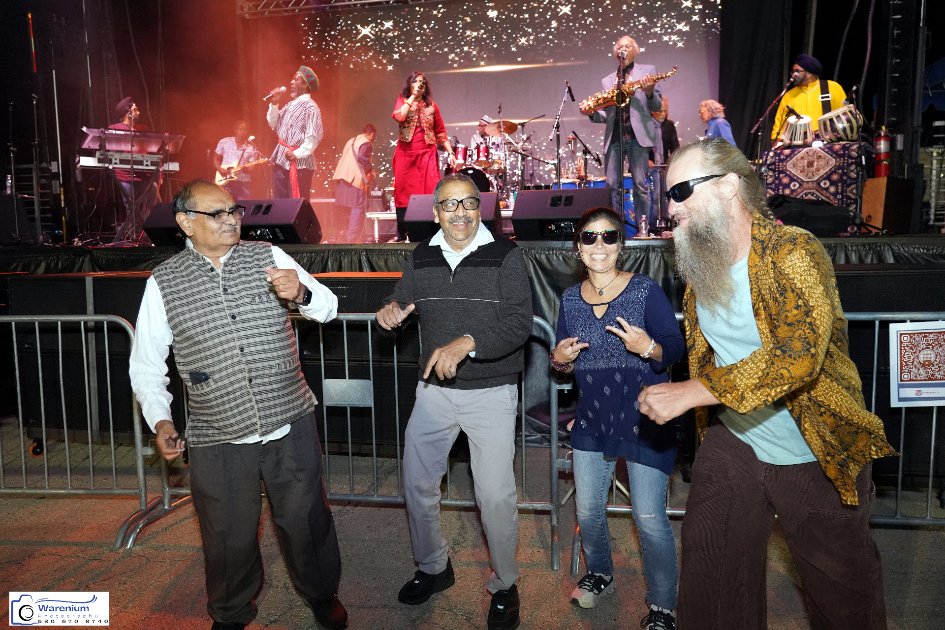 Festival guests dancing near the stage while the live band performs on Day 4