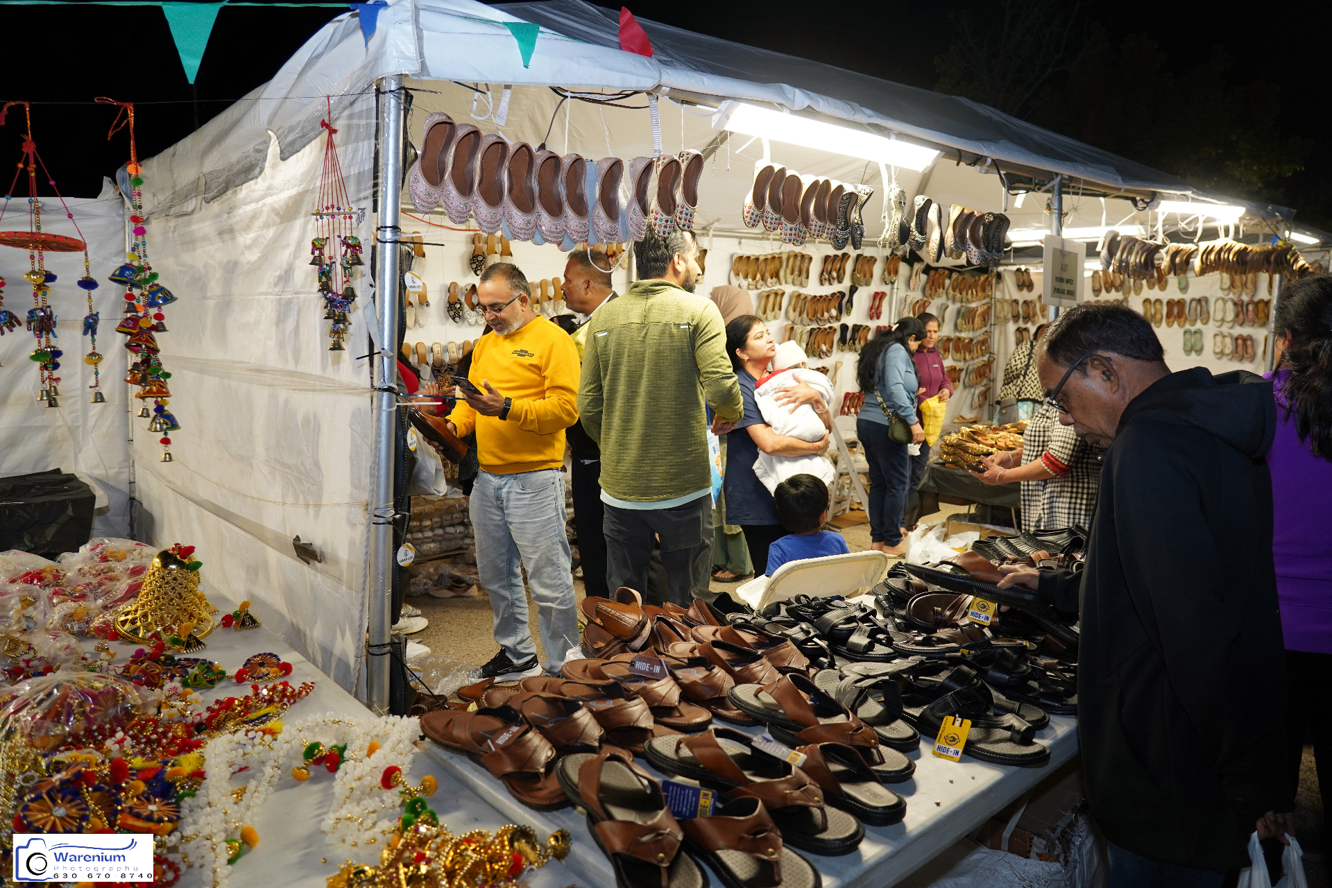 Handcrafted footwear and festive decor displayed at a busy Day 4 bazaar stall